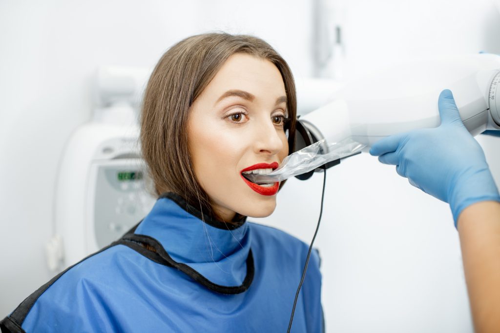 Woman making dental x-ray shot